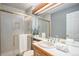Bathroom features a shower with glass doors, wooden cabinets, and a well-lit vanity area at 5821 S Quatar Cir, Centennial, CO 80015