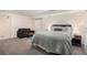 Cozy bedroom with a comfortable bed, stylish seating area, and ample natural light from the window at 5821 S Quatar Cir, Centennial, CO 80015