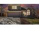 Charming two-story home featuring a brick facade, manicured lawn, and attached two-car garage at 5821 S Quatar Cir, Centennial, CO 80015