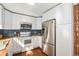 Modern kitchen with stainless steel appliances, white cabinets, and subway tile backsplash at 5821 S Quatar Cir, Centennial, CO 80015