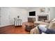 Living room with hardwood floors, fireplace, neutral tones, and comfortable seating at 5821 S Quatar Cir, Centennial, CO 80015