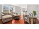 Bright and inviting living room with large windows, comfortable seating, and hardwood floors at 5821 S Quatar Cir, Centennial, CO 80015