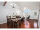 Open-concept living area with hardwood floors, dining table, and ample natural light at 5821 S Quatar Cir, Centennial, CO 80015