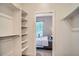 Walk-in closet with adjustable shelving and a view into the bedroom at 1919 W 46Th Ave # 3, Denver, CO 80211
