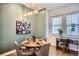 Elegant dining area featuring stylish decor, modern lighting, and a dedicated workspace by a window at 1919 W 46Th Ave # 3, Denver, CO 80211