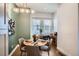 Cozy dining area with a modern light fixture, a small desk, and natural light from two windows at 1919 W 46Th Ave # 3, Denver, CO 80211