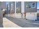Modern townhome exteriors showcasing stylish gray and white siding and attached garages at 1919 W 46Th Ave # 3, Denver, CO 80211