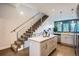 Open-concept kitchen featuring a center island, modern appliances, plenty of storage, and a staircase nearby at 1919 W 46Th Ave # 3, Denver, CO 80211
