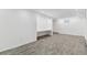 Finished basement featuring modern gray wood-look flooring and built-in desk space at 1440 S Logan St, Denver, CO 80210