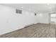 Spacious finished basement boasts recessed lighting and gray wood-look flooring at 1440 S Logan St, Denver, CO 80210