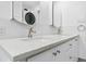 Elegant bathroom features a marble countertop with double sinks, modern fixtures, and ample cabinet storage at 1440 S Logan St, Denver, CO 80210
