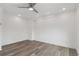 Well-lit bedroom with ceiling fan and wood-look floors at 1440 S Logan St, Denver, CO 80210