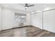 Bright bedroom featuring hardwood floors, large window with blinds, and spacious closet space at 1440 S Logan St, Denver, CO 80210