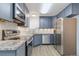 Modern kitchen featuring stainless steel appliances and granite countertops at 1440 S Logan St, Denver, CO 80210