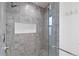 Shower with gray tile, built-in seat, and glass enclosure at 1440 S Logan St, Denver, CO 80210