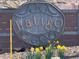 Attractive Latigo community sign surrounded by bright, yellow flowers at 553 Hanging Rock Pl, Castle Rock, CO 80108