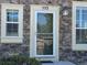 Close-up of the front entrance with stone facade and complementary trim at 553 Hanging Rock Pl, Castle Rock, CO 80108