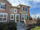 Beautiful two-story townhouse with stone and siding exterior and a cozy front porch at 553 Hanging Rock Pl, Castle Rock, CO 80108