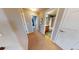 Hallway with carpeted floor and white trim, with doorways to other rooms at 553 Hanging Rock Pl, Castle Rock, CO 80108