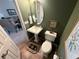 Well-appointed powder room with a pedestal sink, decorative accents, and tiled flooring at 553 Hanging Rock Pl, Castle Rock, CO 80108