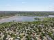 Expansive aerial view showcasing the neighborhood, nearby lake, and recreational areas with trees and green spaces at 4858 S Quintero Cir, Aurora, CO 80015