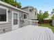 Back deck next to light-gray house with a wooden fence and a small lawn at 4858 S Quintero Cir, Aurora, CO 80015