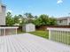 Backyard featuring a shed, grass, trees, and a white deck at 4858 S Quintero Cir, Aurora, CO 80015