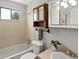 Bathroom featuring a combination tub and shower, vanity and neutral finishes at 4858 S Quintero Cir, Aurora, CO 80015