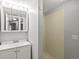 Bathroom with a vanity sink, mirrored medicine cabinet, and tiled shower at 4858 S Quintero Cir, Aurora, CO 80015