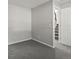 Bedroom with neutral walls, carpet, and trim opens to hallway and stairs at 4858 S Quintero Cir, Aurora, CO 80015