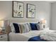Close up of bedroom showcasing a stylish upholstered headboard with decorative pillows at 4858 S Quintero Cir, Aurora, CO 80015