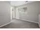 Bright bedroom features carpeted floors, neutral paint and trim, a window, and a closet at 4858 S Quintero Cir, Aurora, CO 80015