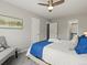 Spacious bedroom with a ceiling fan, ample closet space and gray walls and carpet at 4858 S Quintero Cir, Aurora, CO 80015