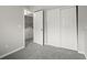 Bedroom with neutral walls and carpet near laundry area with washer and dryer at 4858 S Quintero Cir, Aurora, CO 80015