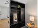 Hallway built-ins provides stylish storage with a table lamp for functional decor and design at 4858 S Quintero Cir, Aurora, CO 80015