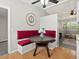 Cozy dining area featuring a round table with banquette seating, next to the bright living room space at 4858 S Quintero Cir, Aurora, CO 80015