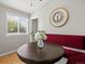 Charming dining nook boasts a wood table, bench seating, and bright natural light from the window at 4858 S Quintero Cir, Aurora, CO 80015