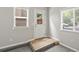 Entryway with tile platform, neutral walls, good light, and gray carpet at 4858 S Quintero Cir, Aurora, CO 80015