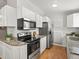 A kitchen features stainless steel appliances and ample cabinet space at 4858 S Quintero Cir, Aurora, CO 80015