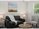 Cozy living room offers a comfortable sofa, side tables with lamps, and a stylish woven table at 4858 S Quintero Cir, Aurora, CO 80015