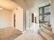 Inviting foyer with tile and carpet flooring, leading to the living areas and staircase at 4941 Silverleaf Ave, Firestone, CO 80504