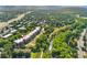 Stunning aerial view of the complex surrounded by lush greenery, a stream, and mountain views at 6000 W Floyd Ave # 214, Denver, CO 80227