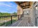 Spacious outdoor balcony with wood floors, wrought iron railing and beautiful views at 6000 W Floyd Ave # 214, Denver, CO 80227
