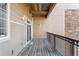 Outdoor balcony with wood flooring and black metal railings at 6000 W Floyd Ave # 214, Denver, CO 80227
