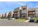 Modern apartment complex featuring stacked stone, balconies, and well-maintained landscaping at 6000 W Floyd Ave # 214, Denver, CO 80227