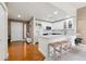 Bright kitchen with stainless appliances, white cabinetry and an island with bar seating at 6000 W Floyd Ave # 214, Denver, CO 80227