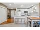 Bright kitchen features white cabinetry, modern lighting and stainless appliances at 6000 W Floyd Ave # 214, Denver, CO 80227