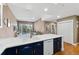 Bright open-concept kitchen with white counters and dark cabinetry overlooking the living area at 6000 W Floyd Ave # 214, Denver, CO 80227