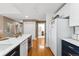Open concept kitchen with white counters and stainless steel appliances at 6000 W Floyd Ave # 214, Denver, CO 80227