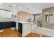 Open concept kitchen featuring two-toned cabinets with eat-in counter space at 6000 W Floyd Ave # 214, Denver, CO 80227